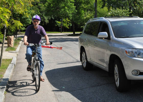 With the car shoo cars stay at least 3 feet away from the bicyle.  This is safe.  It is like having your own bike lane.